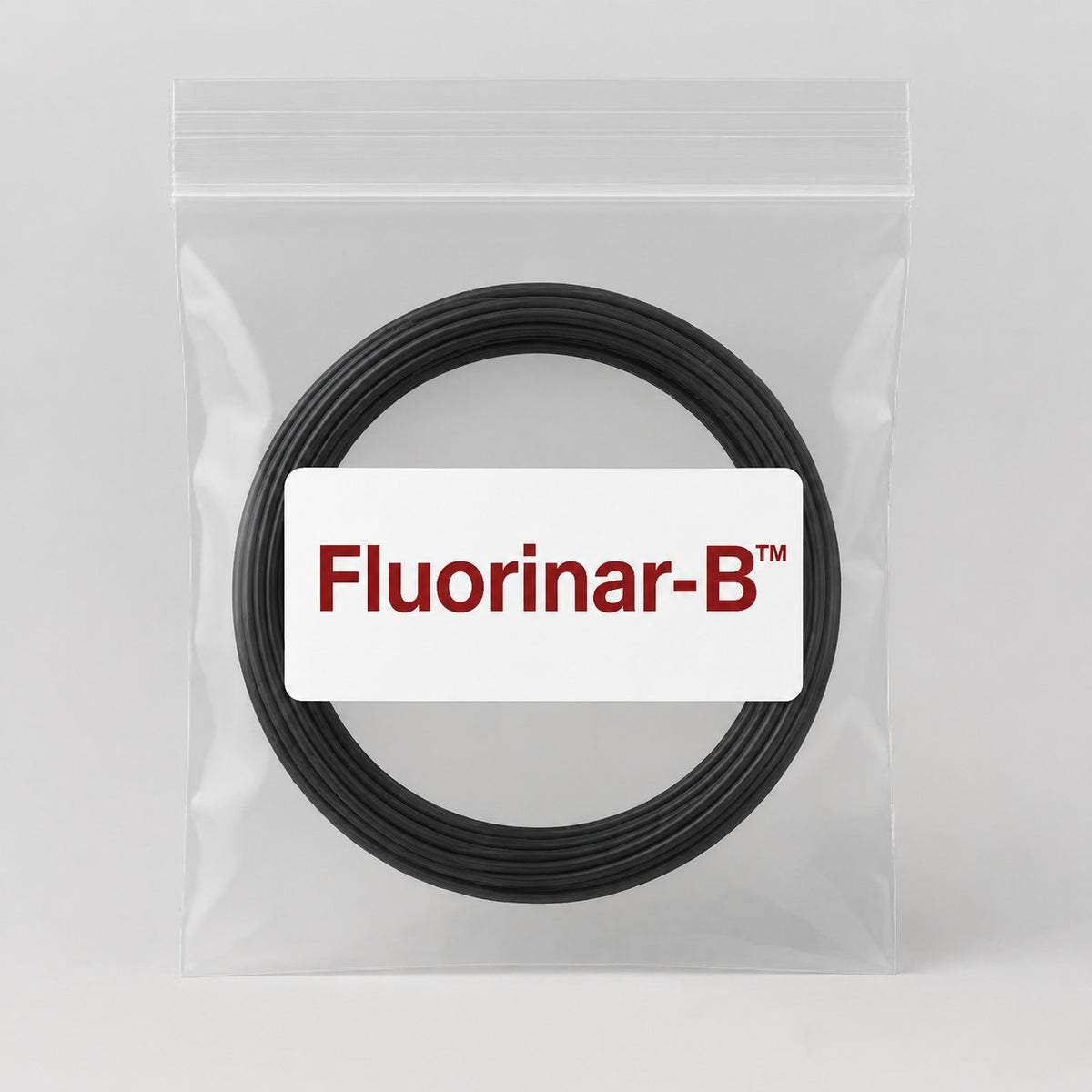 Fluorinar-B black PVDF 100 g filament sample in a clear resealable bag.