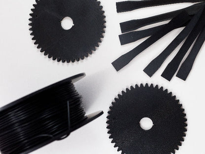 Black gears and test pieces 3D printed with Fluorinar-B™ PVDF filament.