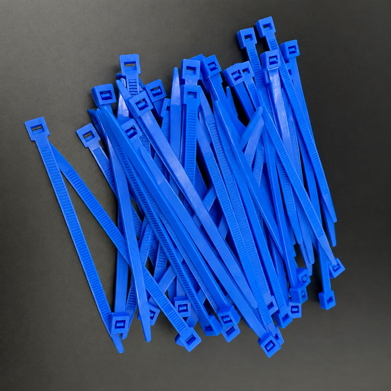 Blue Strong-Ty® PVDF cable ties spread across a dark surface.